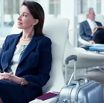 Businesswoman with suitcase waiting in a.webp