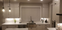 Modern kitchen with solar shades and matching fabric valance installed by Hands-On Home Services in