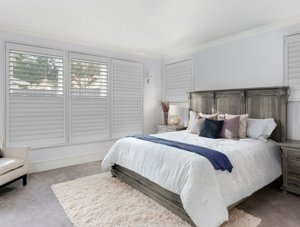 Modern bedroom with split tilt and invisible tilt Woodlore shutters by Norman installed by Hands-On Home Services NJ