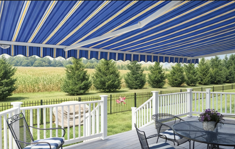 Striped Aristocrat Motorized retractable awning shading a wooden deck with outdoor chairs and railing, installed in Northern NJ, in the town of Chester, Morris County.