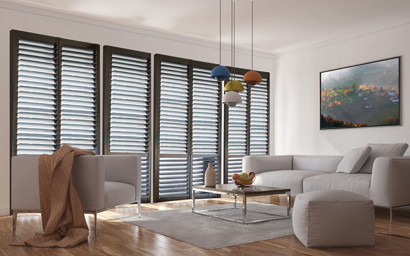 Modern living room featuring dark Brightwood shutters by Norman, adding dramatic contrast and contemporary appeal.
