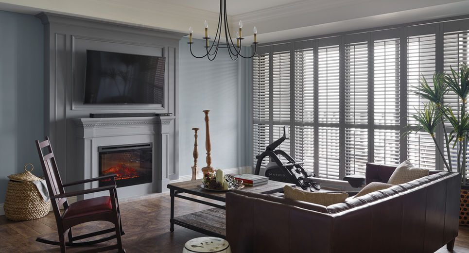 Living room with full-height shutters and modern furnishings 