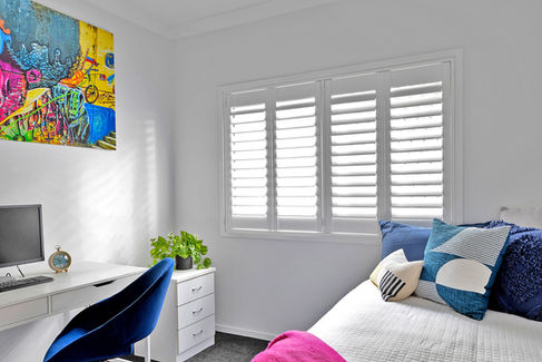 White Woodlore shutters by Norman installed in modern home office for light control and style
