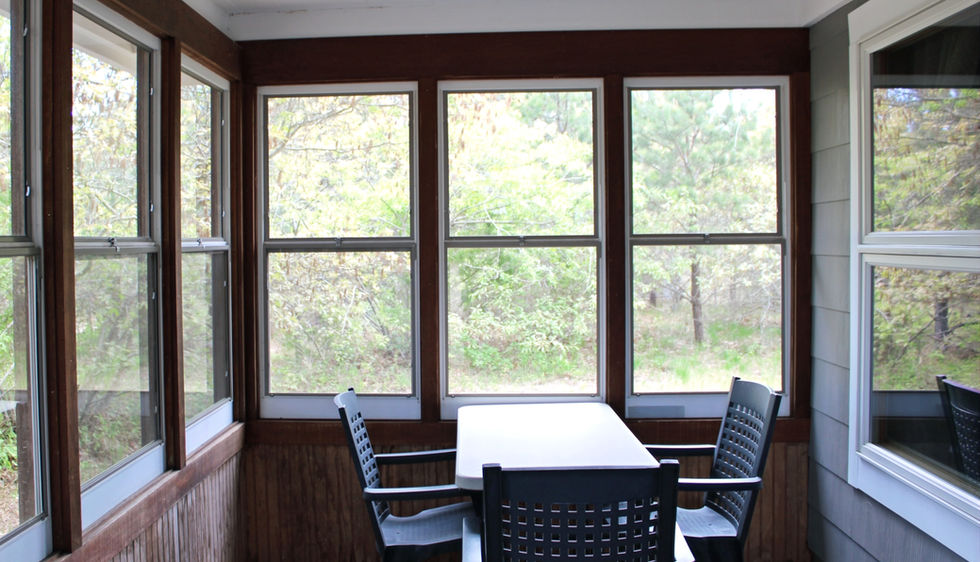 screened in porch with seating area