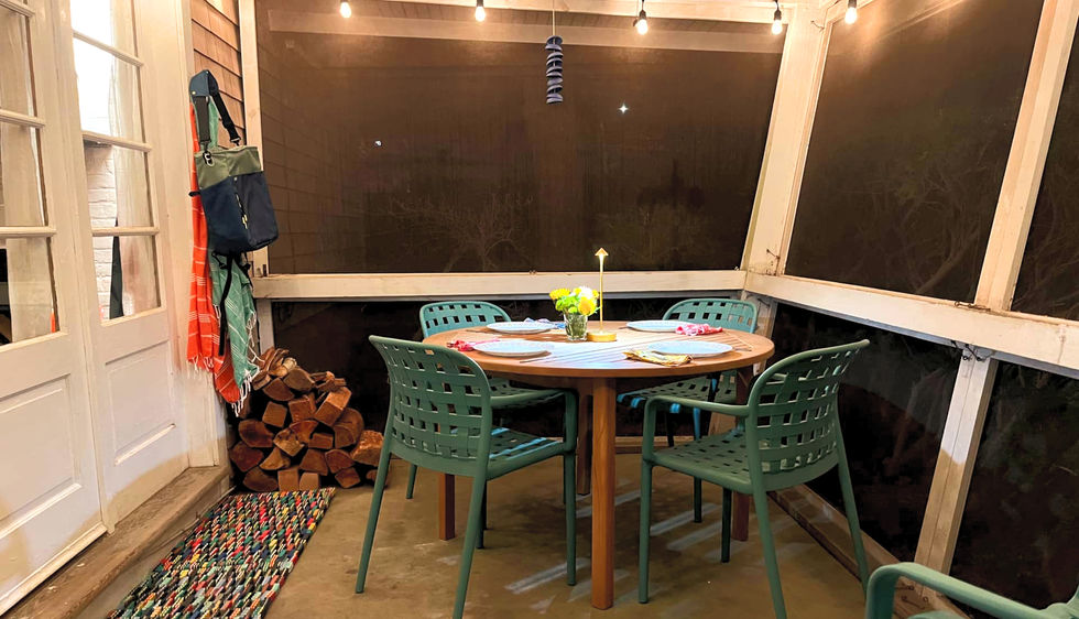 screened in porch with dining area and porch lighting