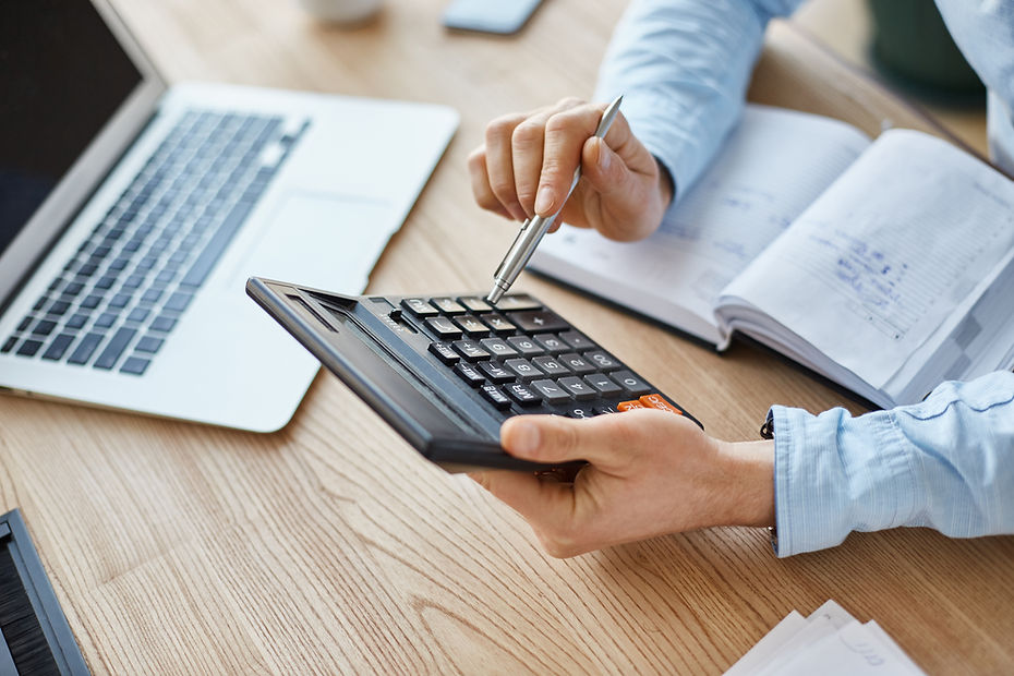 cropped-view-professional-serious-finance-manager-holding-calculator-hands-checking-compan