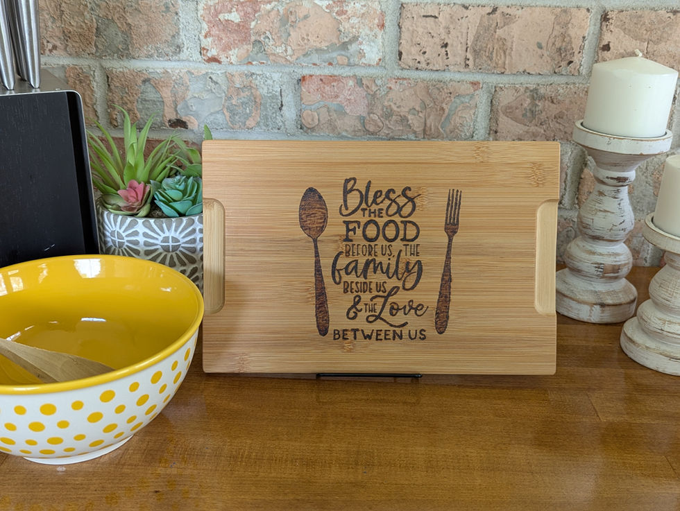 cutting board reads: Bless the food before us, the family beside us, and the love between us.
