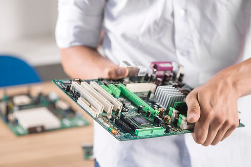close-up-male-technician-holding-computer-motherboard.jpg