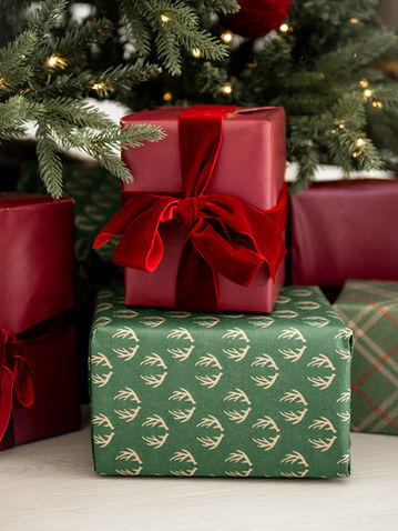Red and green wrapped Christmas presents topped with red bows.