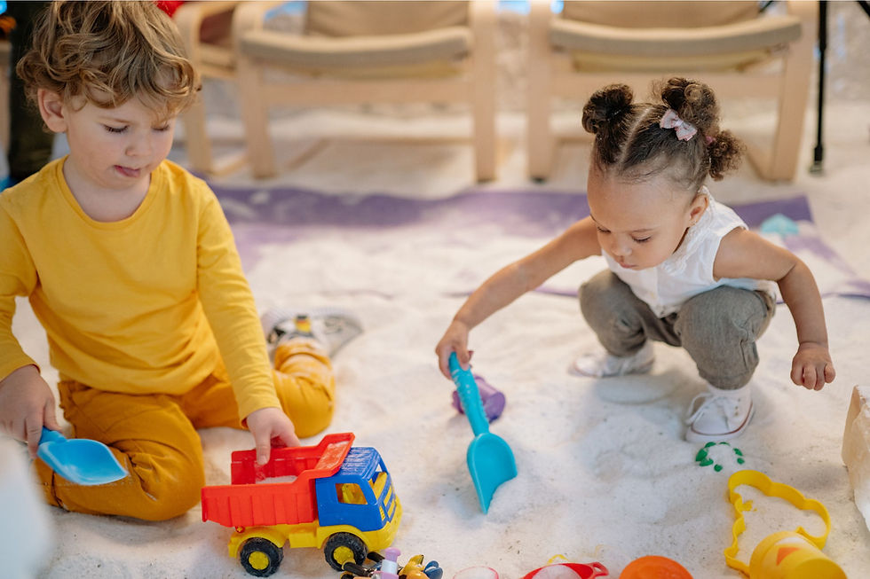 Two children playing in a sandbox