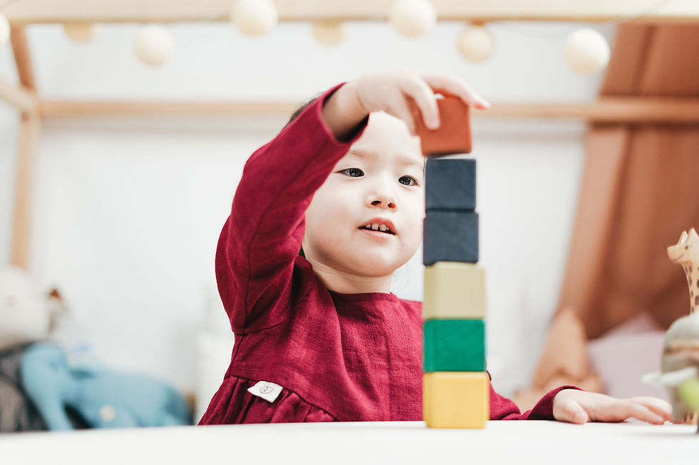 A child building with colored blocks