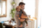 A father holds a sleepy child