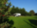 Caravan with awning in sunny meadow