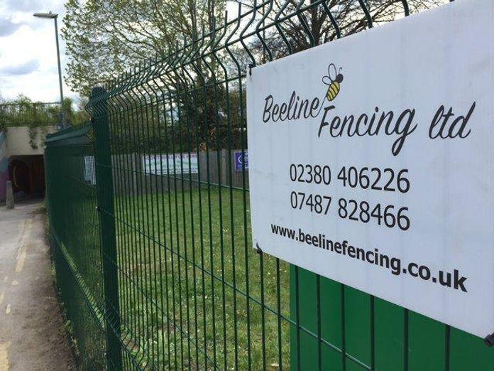 Green security fencing with Beeline signage.jpg