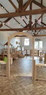 Rustic indoor playground with wooden play structures