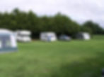 Caravans parked in field