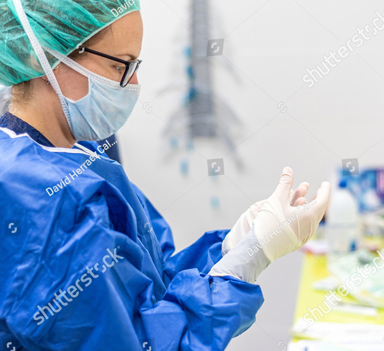 stock-photo-covid-female-nurse-puts-on-protective-gloves-personal-protective-equipment-in-