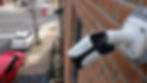 Image of outdoor security camera pointing at city street and sidewalk