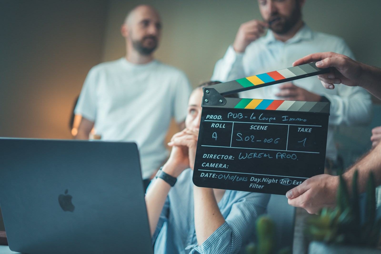 Film clapperboard and laptop representing a clear creature animation studio brief