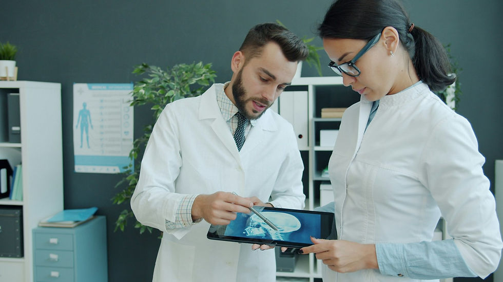 Two doctors reviewing medical imaging on a tablet together