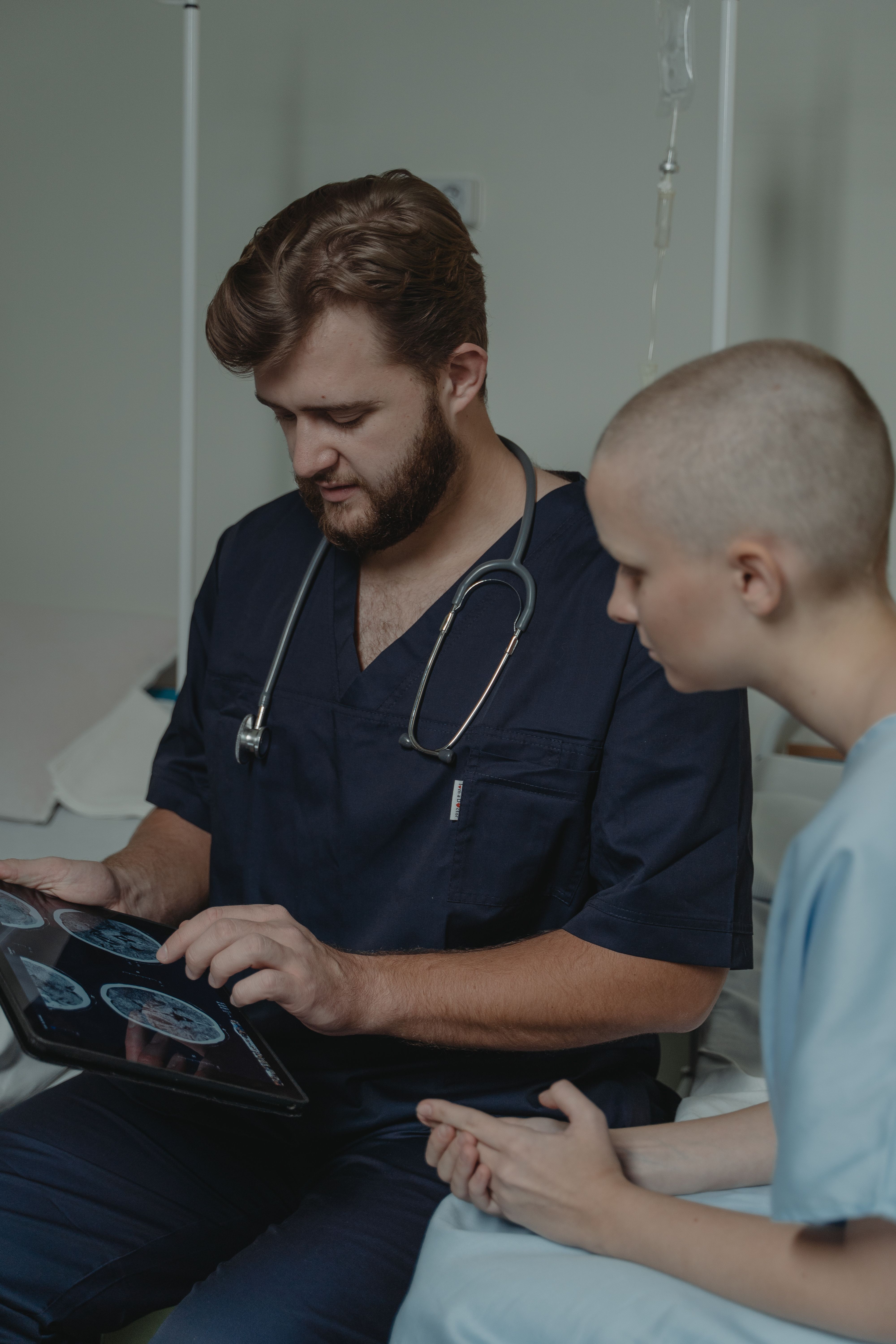Doctor discussing medical imaging information with a patient on a tablet