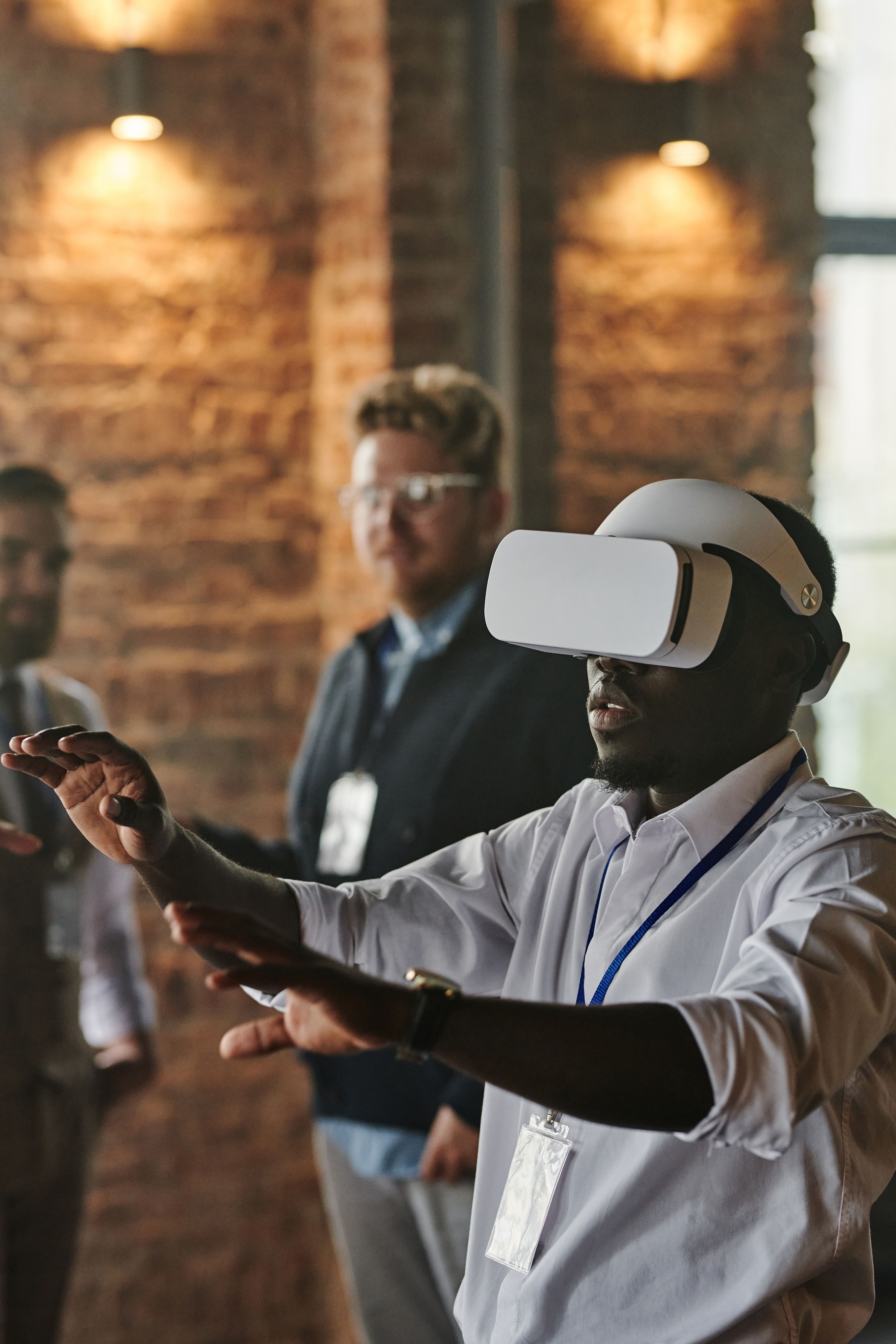 Professional demonstrating a virtual reality headset to colleagues in an office