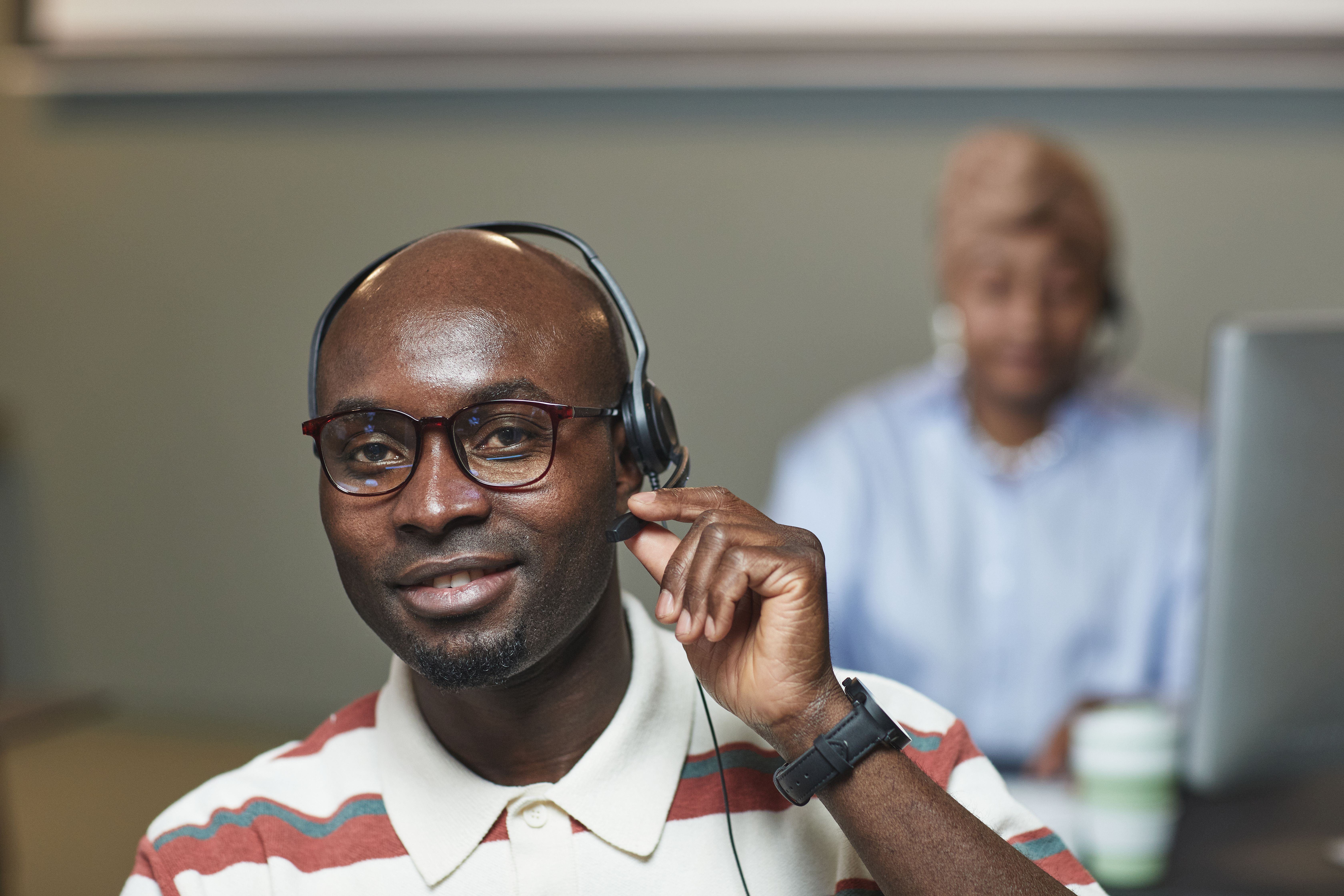 Customer support professional using a headset during service training