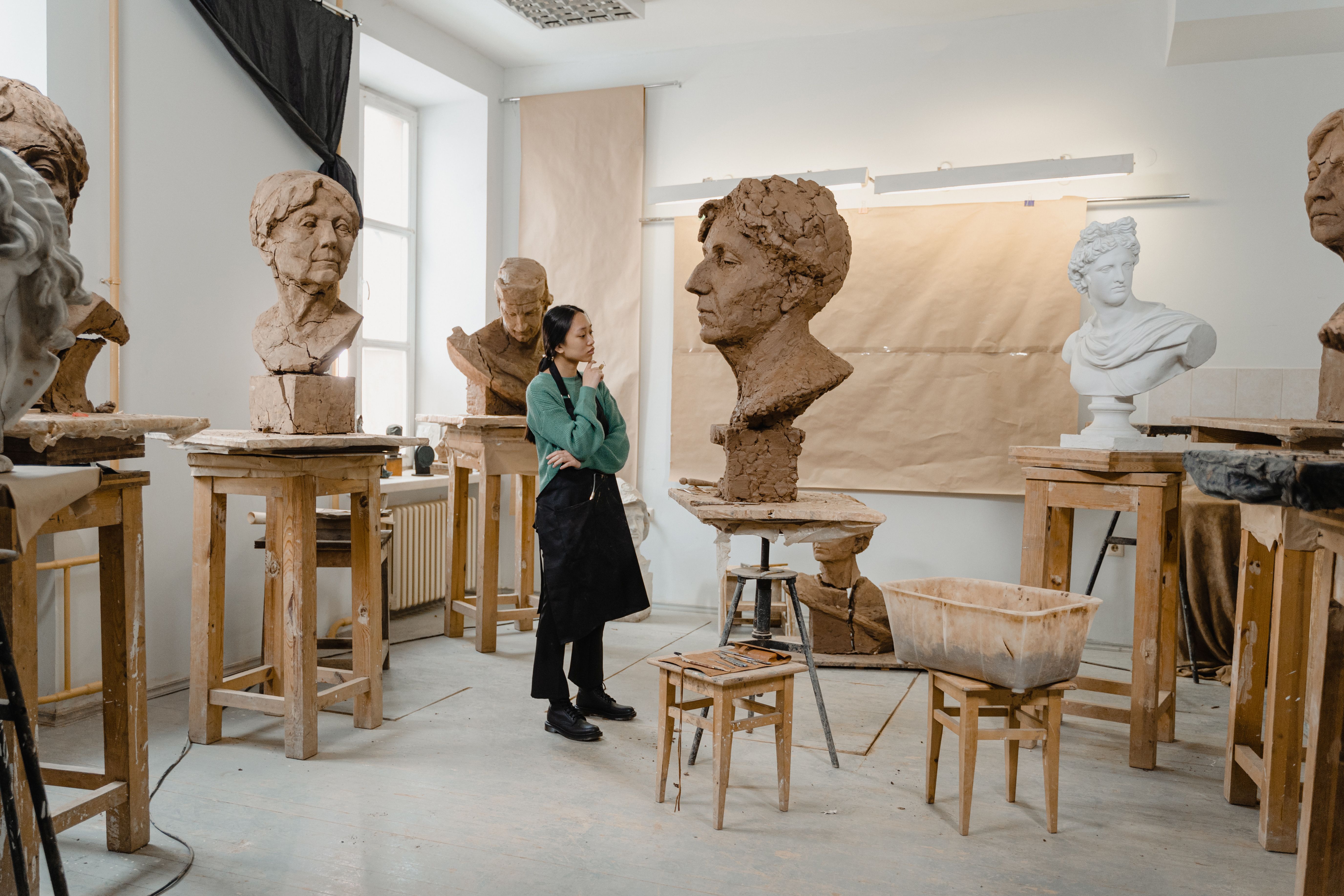 Sculptor developing a three-dimensional creature form in a studio