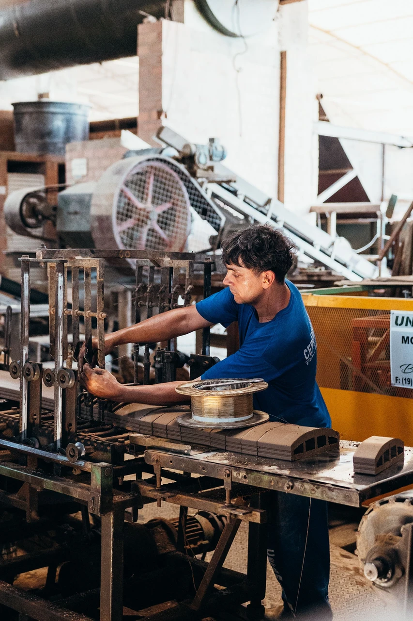 Factory worker inspecting industrial machinery for an AR maintenance task