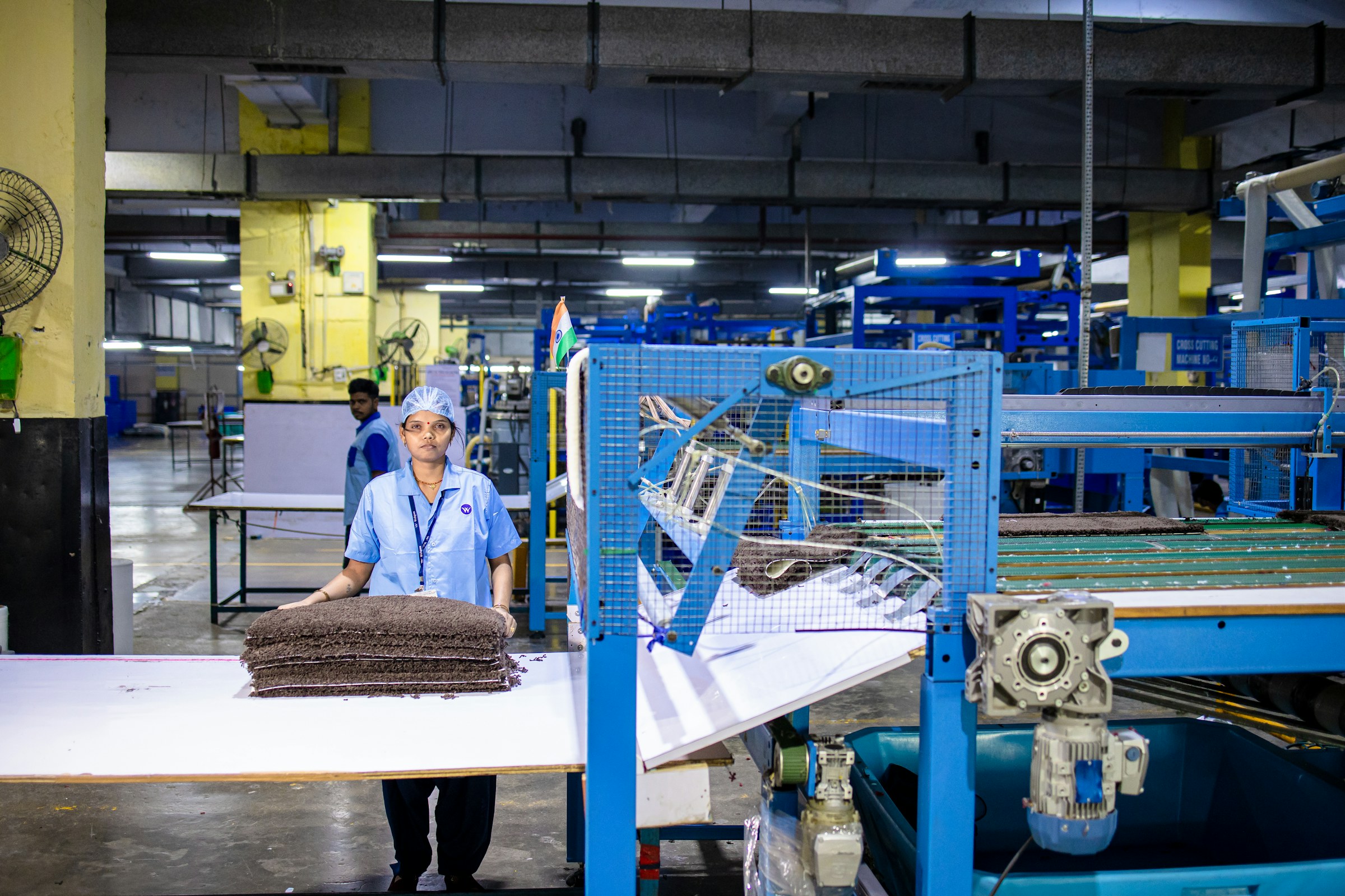 Factory worker on a production line using predictive maintenance software