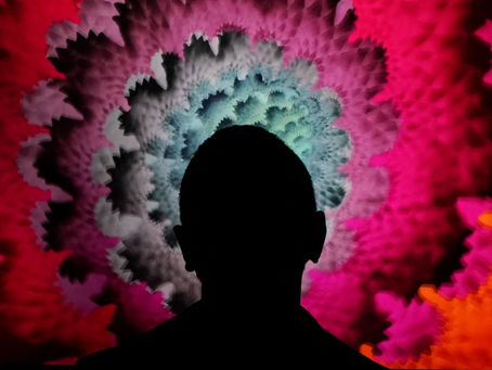 Silhouette of person against a vibrant, abstract background of red, pink, purple, and orange fractal patterns, creating a dramatic mood.