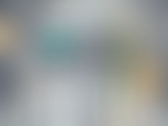 Robots with various colored panels walk through a futuristic lab with glowing lights and machinery, creating a sci-fi atmosphere.