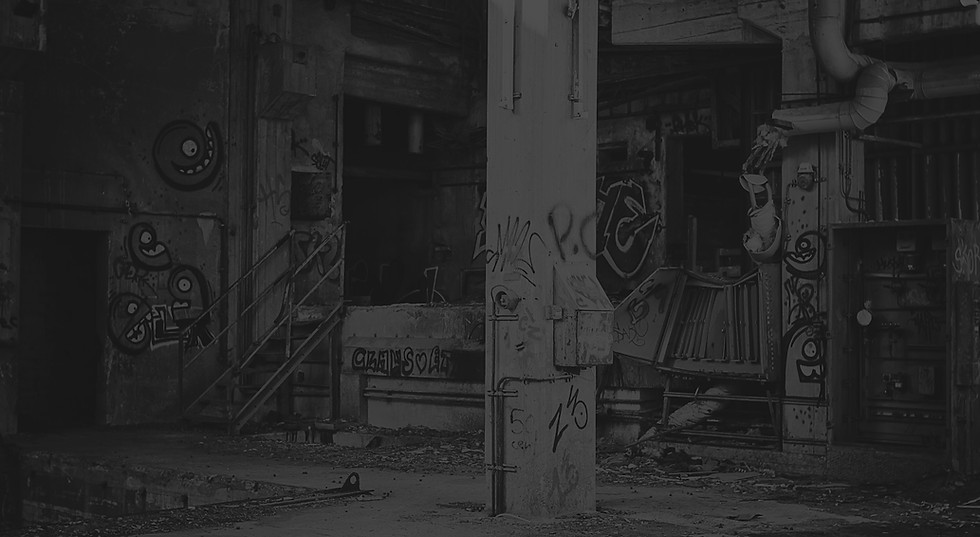 building with white concrete post beside blue machine_edited.jpg