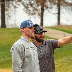 Two junior golfers talking about the next shot and asking questions to be curious and adaptable.