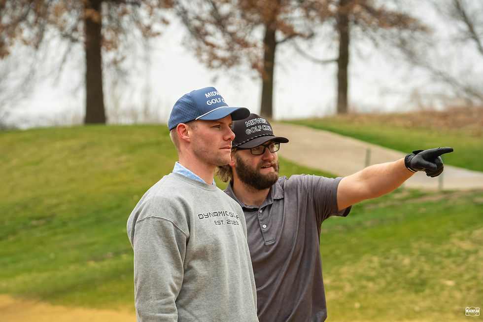 Two junior golfers talking over a shot on the golf course asking questions about what the correct approach is