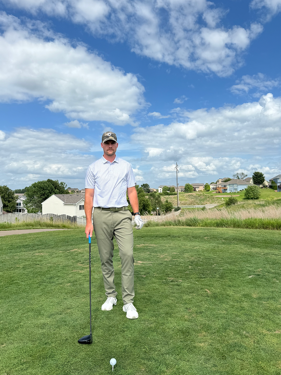 Golfer doing a pre-shot routine before teeing off