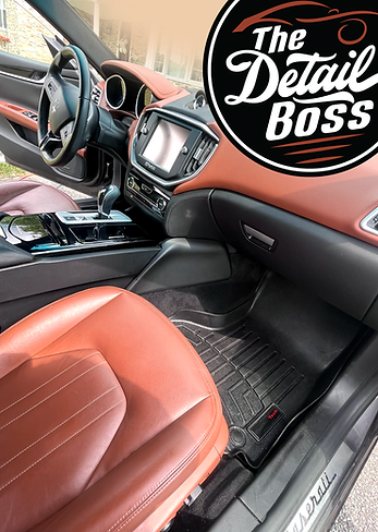 A luxury car after a thorough cleaning. The wheel, dashboard, center console, seats and floor mats all spotless.