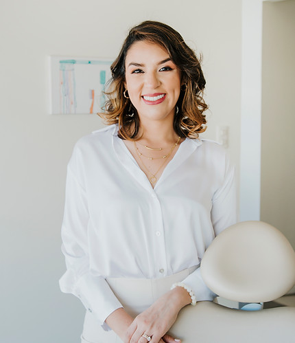 Professional dentist smiling in a clinic, representing the expert-led foundation behind My Smile Academy’s preventive oral he