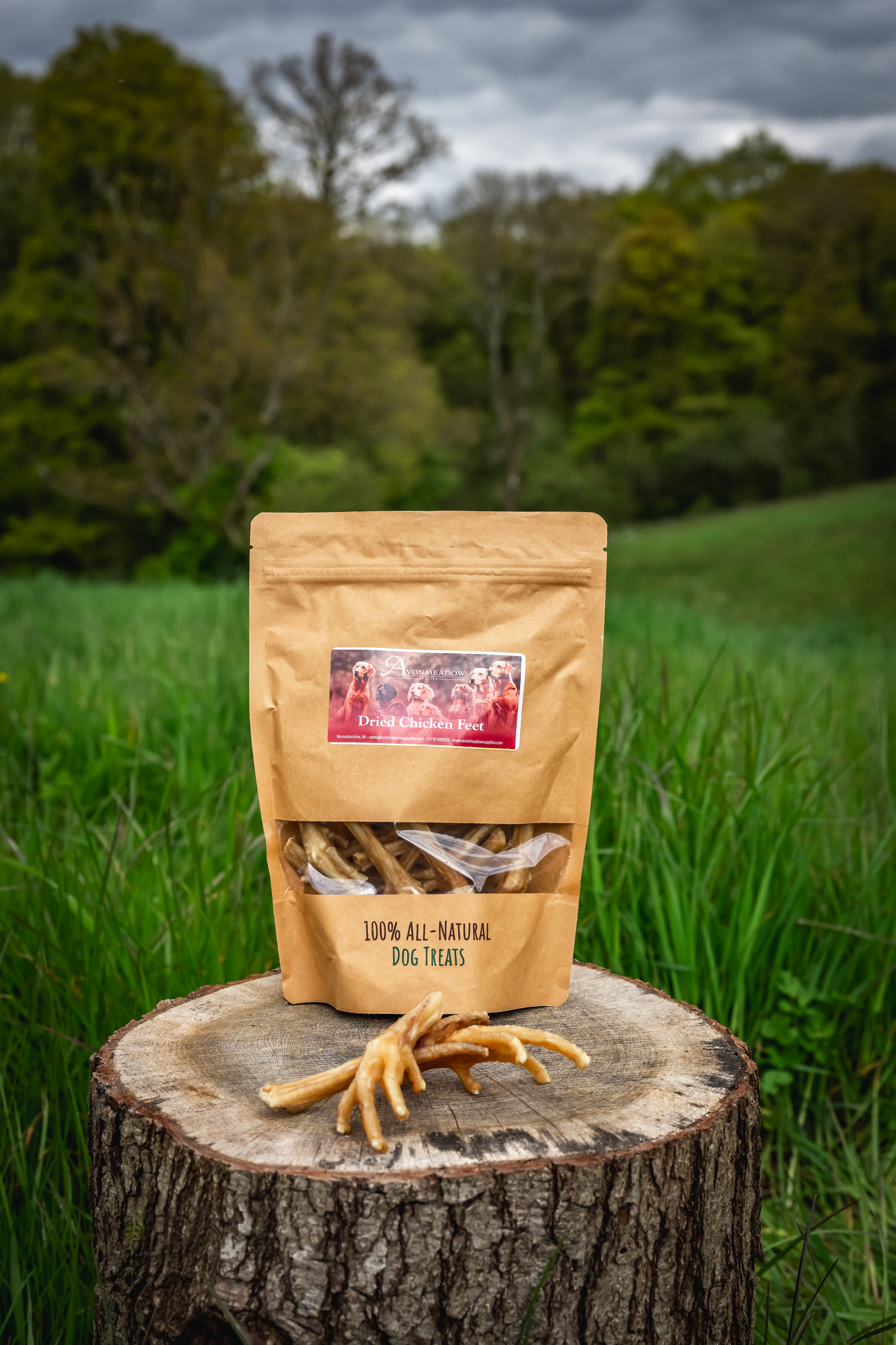 Packet of treats on log in grass backdrop