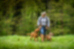 Blonde lady walking with dogs at her heel