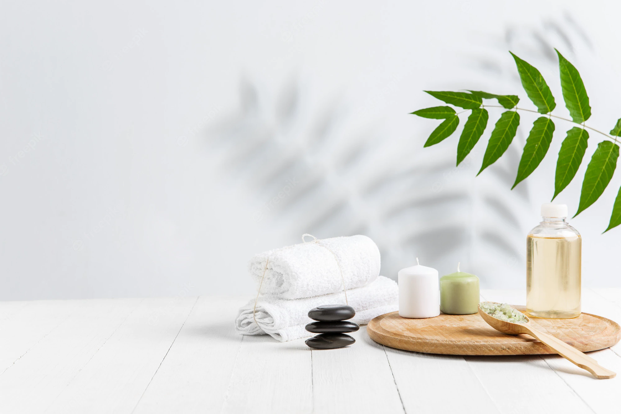 beautiful-spa-composition-massage-table-wellness-center-copyspace_155003-14873.webp