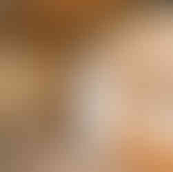 A water tank with newer looking piping sits against a sheet rocked wall in the basement. The sheetrock has some water marking. The sewer line is to the right and goes through the wall of the basement foundation.