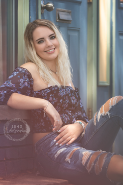 Rosalie against blue brick