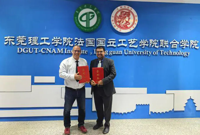 Prof. David Bassir and Dr. Ata Jahangir Moshayedi formalizing the strategic partnership at Dongguan University of Technology.