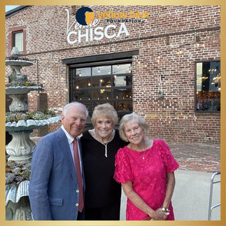 Three people gather outside Venue Chisca