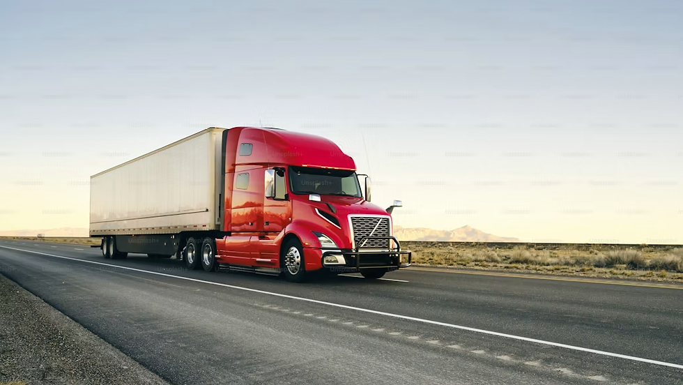Red semi truck with white trailer driving on a пуст? No, English. Red semi truck with white trailer driving on a desert highway at sunset.