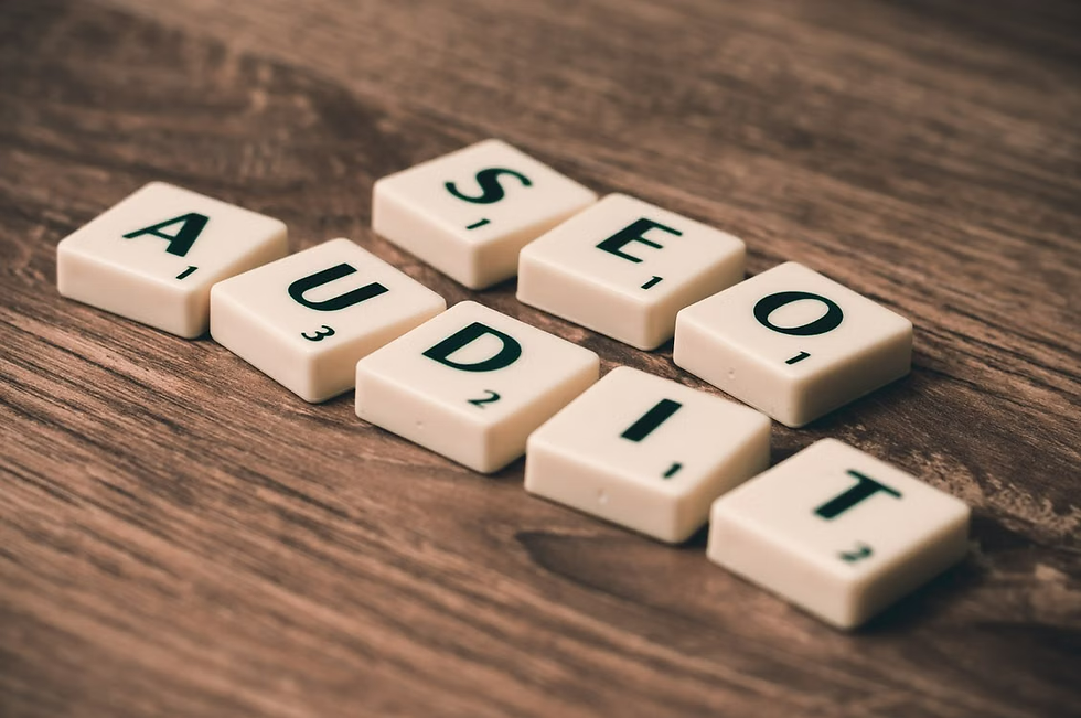 Letter tiles spelling SEO AUDIT on a wooden table, arranged diagonally in a clean, focused office-style scene.