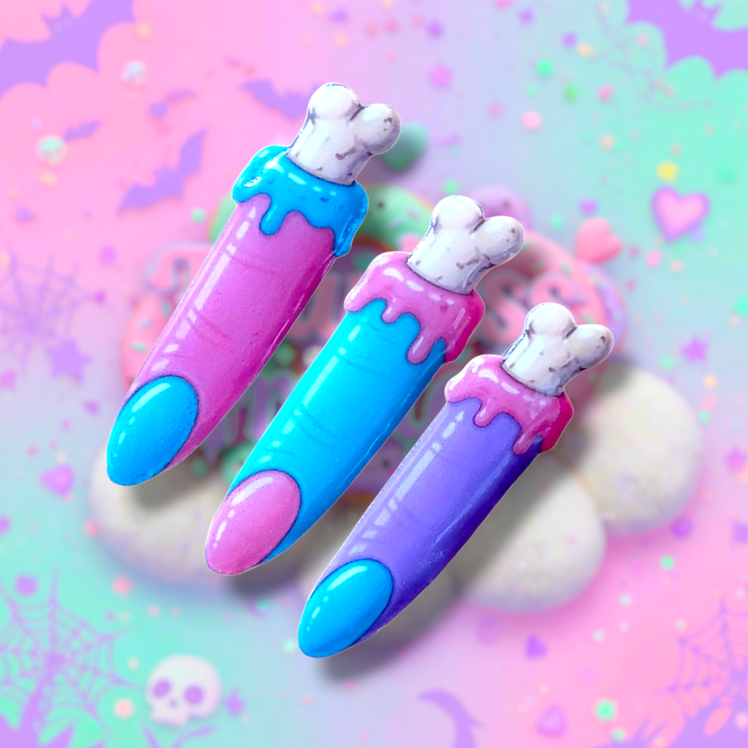 showing all three zombie finger hair clips, pink and teil with white bone, teal,pink, and purple and teal pastel goth hair cl