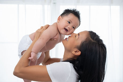 laughing-mother-lifting-her-adorable-newborn-baby-son-air.jpg