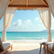 Eye-level view of a luxurious beach club cabana with ocean in the background